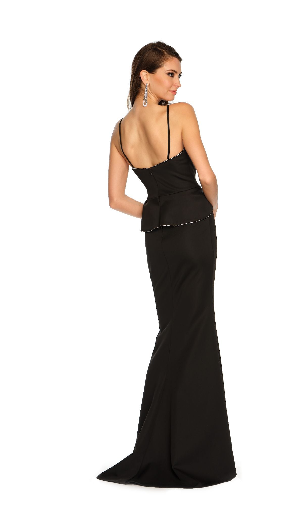 Woman wearing the Dave and Johnny Long Formal Dress 11329—black, fitted, with thin straps and subtle embellishments—standing and looking over her shoulder against a white background.